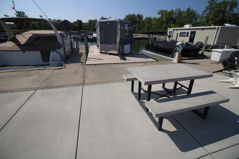 Slide: The Image of Concrete dock with Harbor Home 24' houseboat, 2020 model, and picnic table. - 15