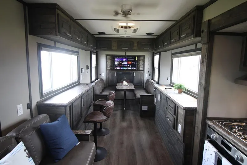 Slide: The Image of Modern interior of 2020 Harbor Home 24' RV with wood cabinets and seating. - 17