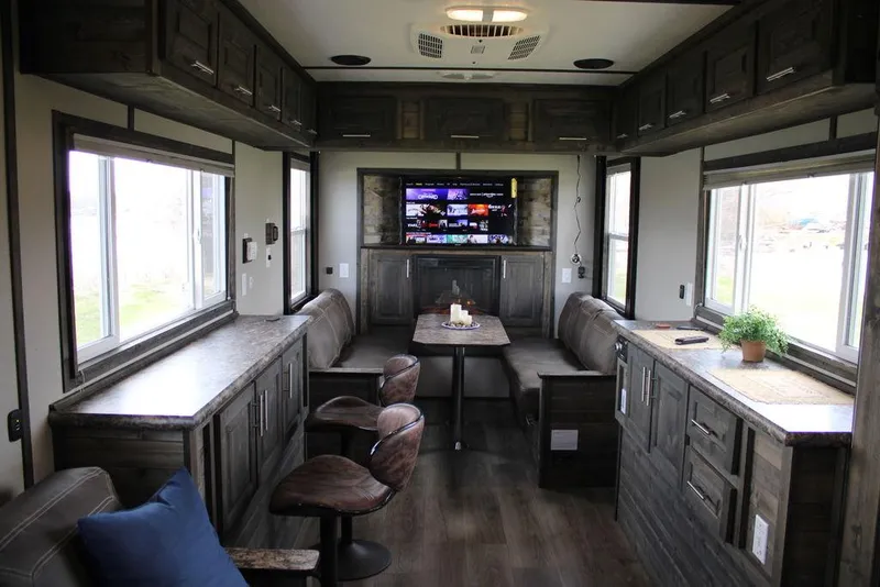 Slide: The Image of Modern interior of 2020 Harbor Home 24' RV with cozy seating and entertainment area. - 20
