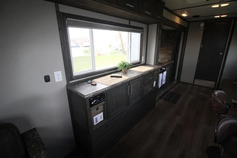 Slide: The Image of Interior of 2020 Harbor Home 24' RV with modern kitchen and large window. - 21