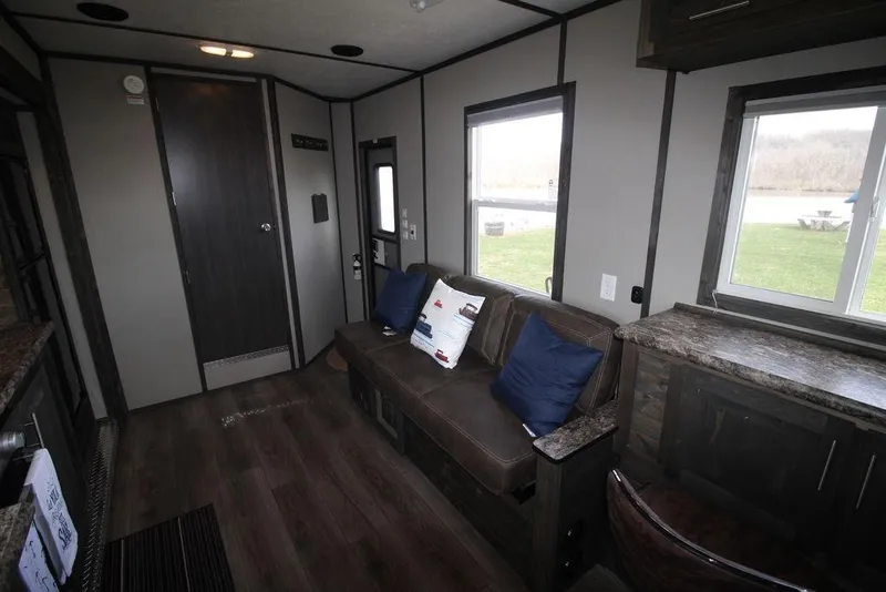 Slide: The Image of Interior of 2020 Harbor Home 24' model with modern furnishings and large windows. - 22