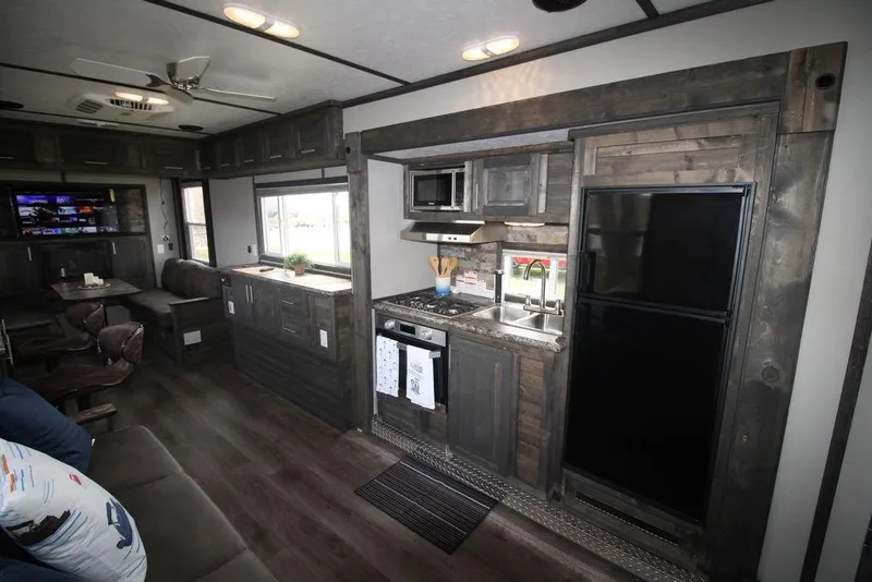 Slide: The Image of 2020 Harbor Home 24' interior with modern kitchen and living area. - 23