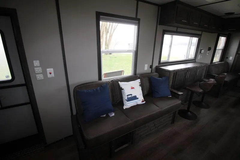 Slide: The Image of Interior of 2020 Harbor Home 24' with sofa, pillows, and large windows. - 25