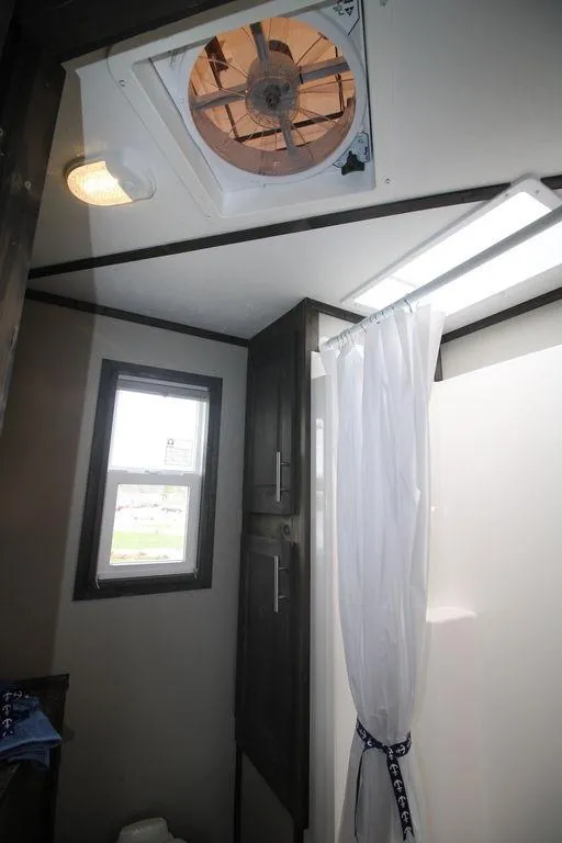 Slide: The Image of 2020 Harbor Home 24' bathroom with shower, window, and ceiling fan. - 27