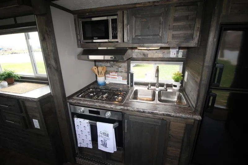 Slide: The Image of Modern kitchen in 2020 Harbor Home 24' model with stainless steel appliances. - 28