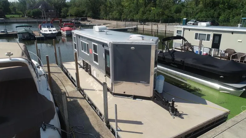 Slide: The Image of Harbor Home 24' 2020 houseboat docked at a marina with other boats. - 5