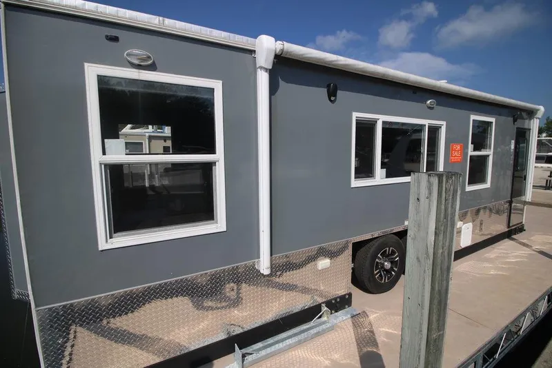 Slide: The Image of 2020 Harbor Home 24' mobile home with gray exterior and multiple windows. - 7