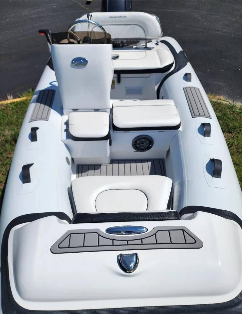 The Image of 2025 Walker Bay Generation 12 LTE inflatable boat interior with seating and steering console. - 0