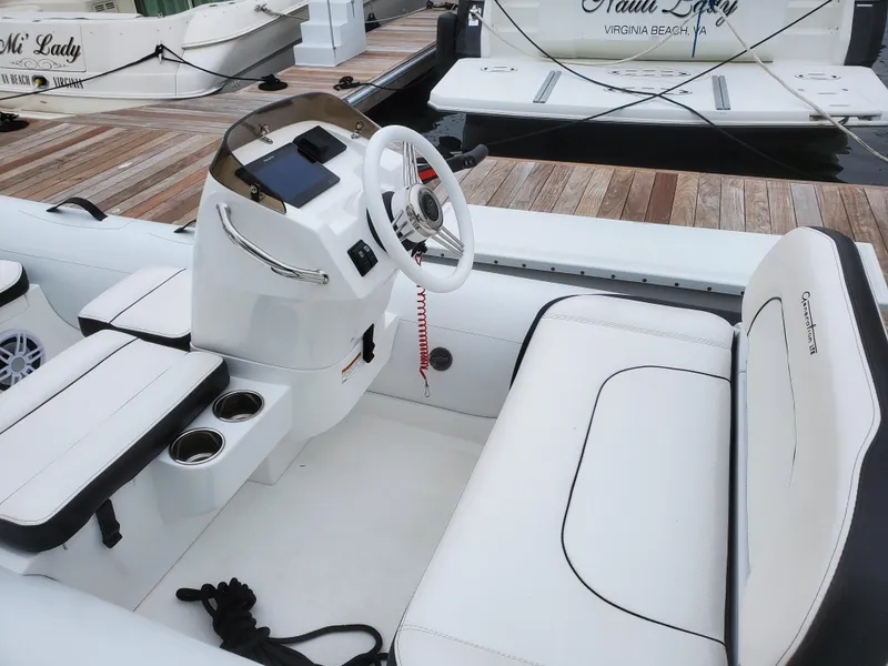 Slide: The Image of 2025 Walker Bay Generation 12 LTE boat interior with white seating and steering console. - 10