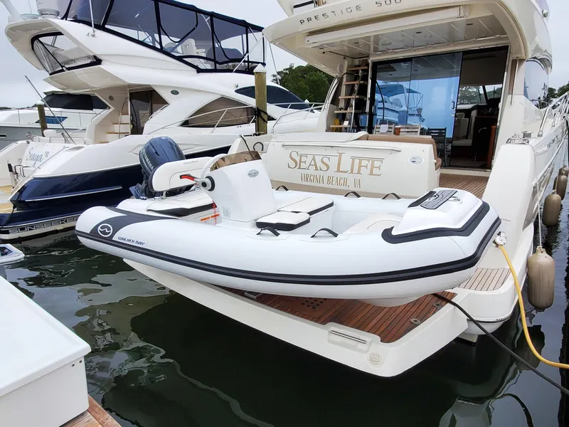 Slide: The Image of 2025 Walker Bay Generation 12 LTE inflatable boat docked on a luxury yacht. - 6