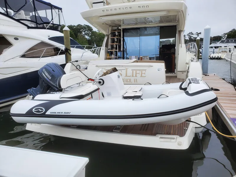 Slide: The Image of 2025 Walker Bay Generation 12 LTE inflatable boat docked on a yacht. - 7