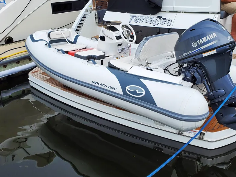 Slide: The Image of 2025 Walker Bay Generation 11 LTE inflatable boat docked with Yamaha outboard motor. - 4