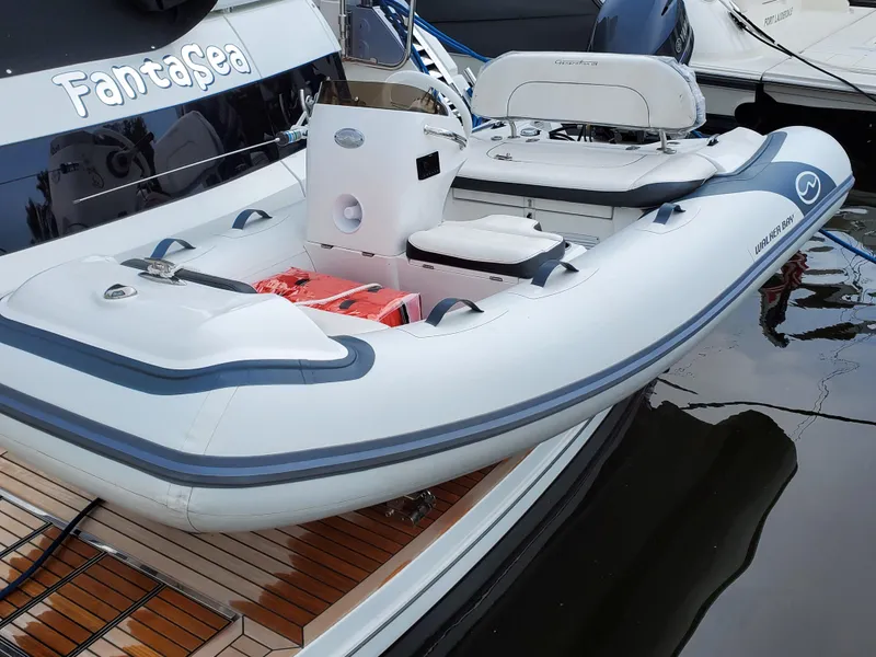 Slide: The Image of Walker Bay Generation 11 LTE 2025 inflatable boat docked by a yacht. - 6