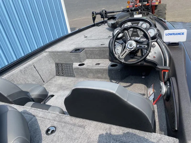 Slide: The Image of 2023 Tracker Pro Team™ 195 TXW boat interior with steering console and seating. - 4