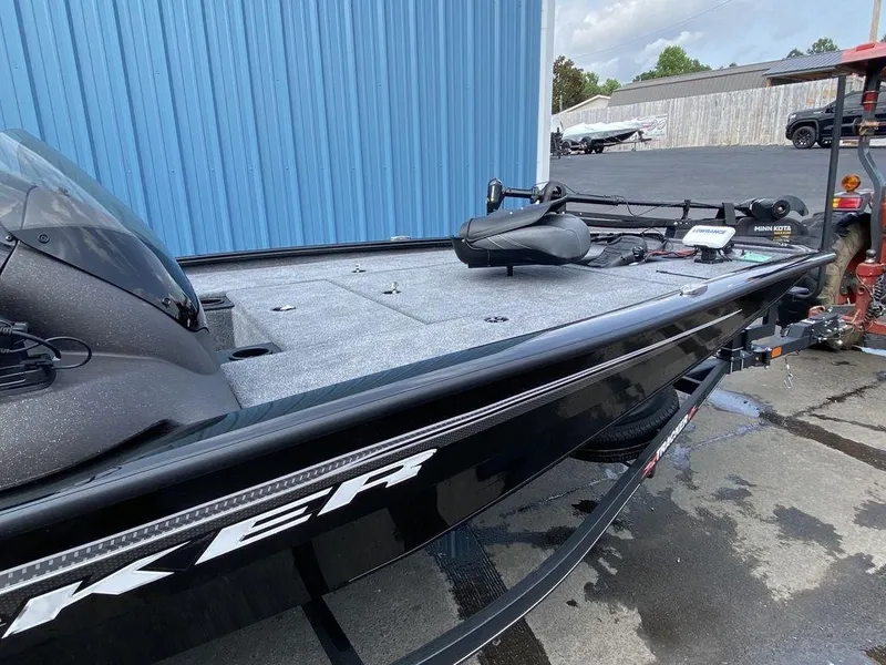 Slide: The Image of 2023 Tracker Pro Team™ 195 TXW fishing boat, black, docked near a blue building. - 5