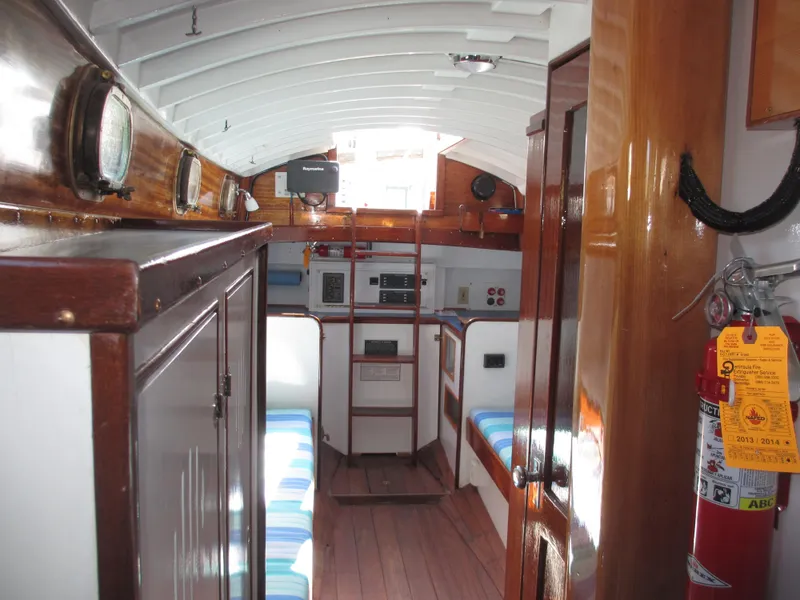Slide: The Image of Interior of a 1957 Sparkman & Stephens K35 sailboat, featuring wooden finishes and nautical equipment. - 14