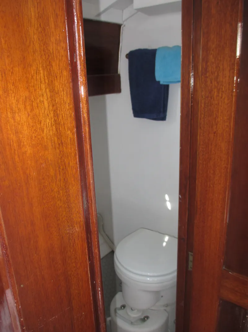 Slide: The Image of 1957 Sparkman & Stephens K35 yacht bathroom with wooden door and towels. - 17