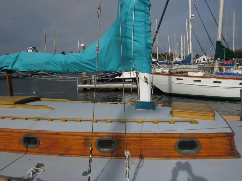 Slide: The Image of 1957 Sparkman & Stephens K35 sailboat with wooden deck and turquoise sail cover. - 4