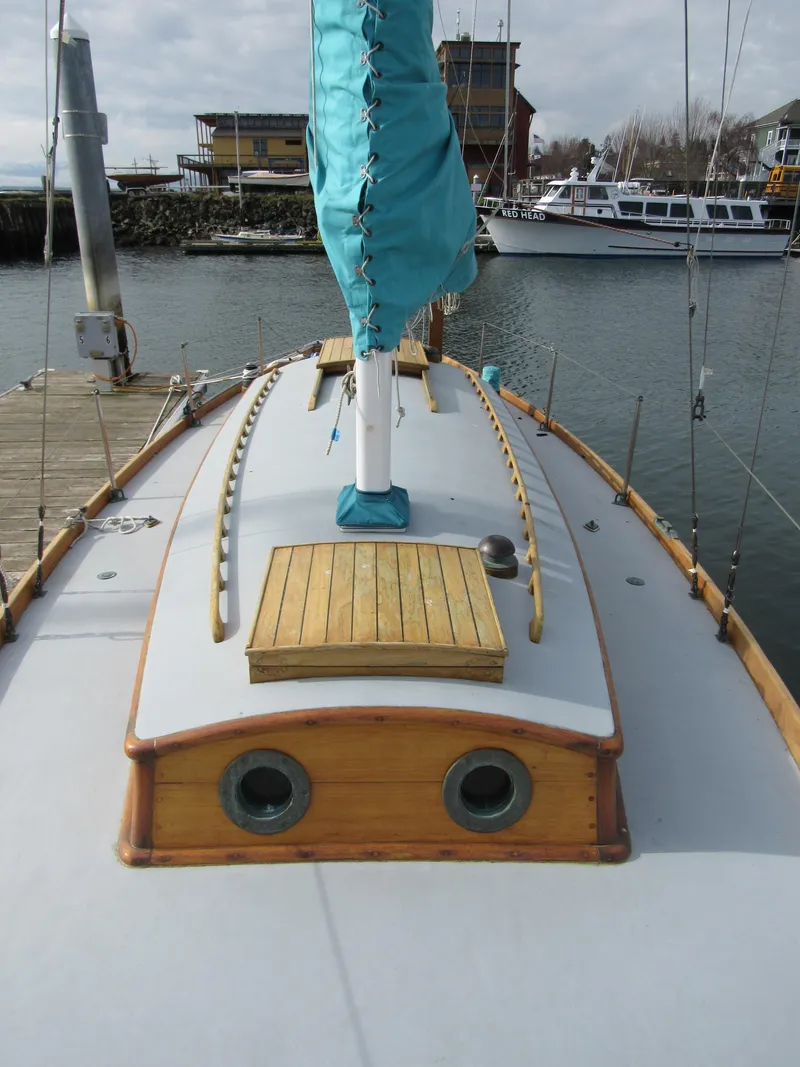 Slide: The Image of 1957 Sparkman & Stephens K35 sailboat with turquoise sail cover, docked in a marina. - 8