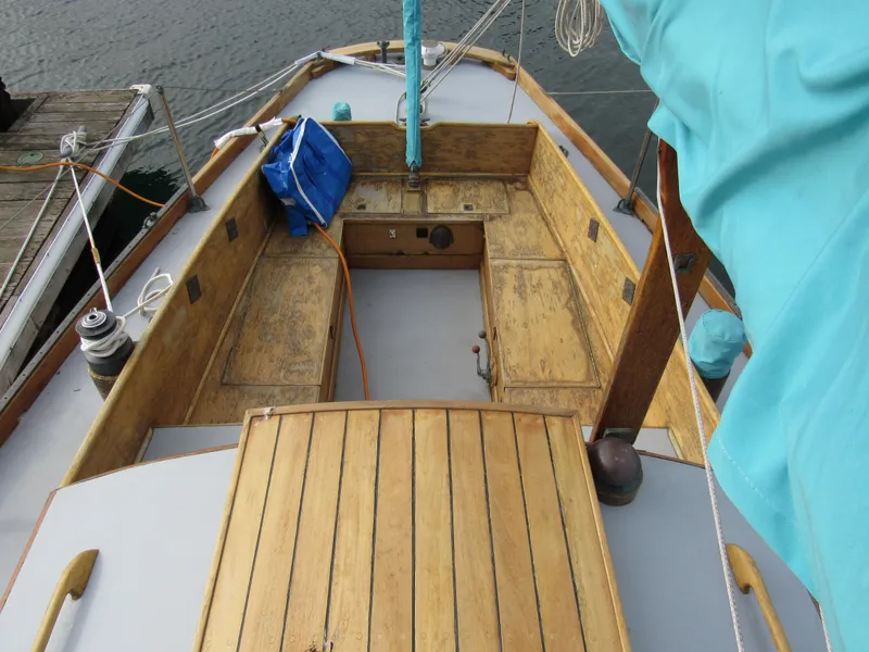 Slide: The Image of 1957 Sparkman & Stephens K35 sailboat with wooden deck and blue sail cover. - 9