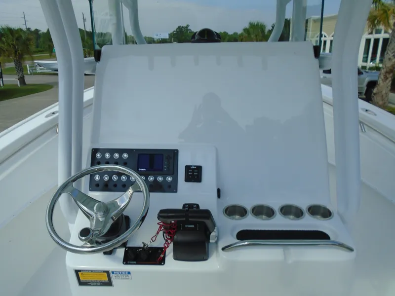 Slide: The Image of 2024 Cape Horn 27XS boat console with steering wheel and controls. - 7