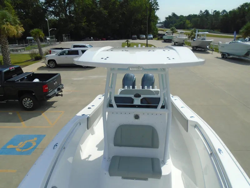 Slide: The Image of 2024 Cape Horn 27XS boat in parking lot with trucks and trees in background. - 9