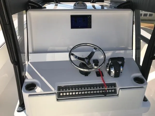 Slide: The Image of 2024 Invincible 36 boat dashboard with steering wheel, controls, and electronic display. - 10