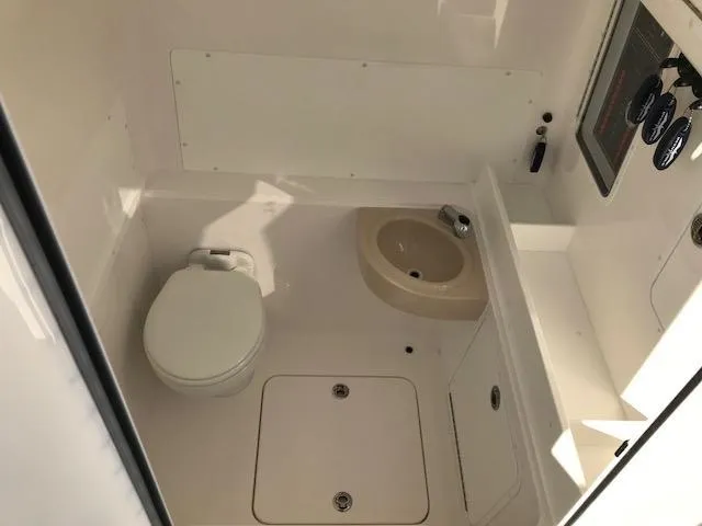 Slide: The Image of 2024 Invincible 36 boat interior bathroom with toilet and sink. - 11