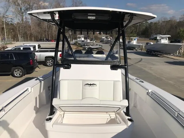 Slide: The Image of 2024 Invincible 36 boat with T-top and seating, docked at marina. - 14