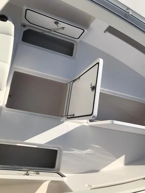 Slide: The Image of 2024 Invincible 36 boat storage compartments and hatches. - 16