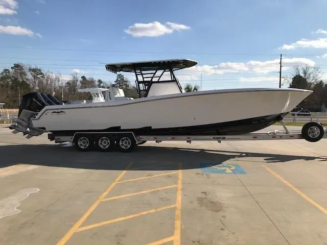 Slide: The Image of 2024 Invincible 36 boat on a trailer in a parking lot. - 3