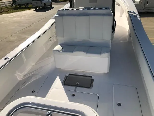 Slide: The Image of 2024 Invincible 36 boat interior with white seating and storage compartments. - 6