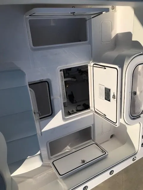 Slide: The Image of 2024 Invincible 36 boat interior with open storage compartments and seating. - 7