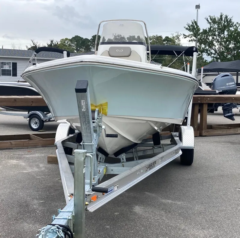 Slide: The Image of 2024 Key West 210 Bay Reef boat on a trailer in a marina. - 2