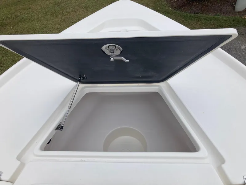 Slide: The Image of 2024 Key West 210 Bay Reef boat storage compartment with open lid. - 12