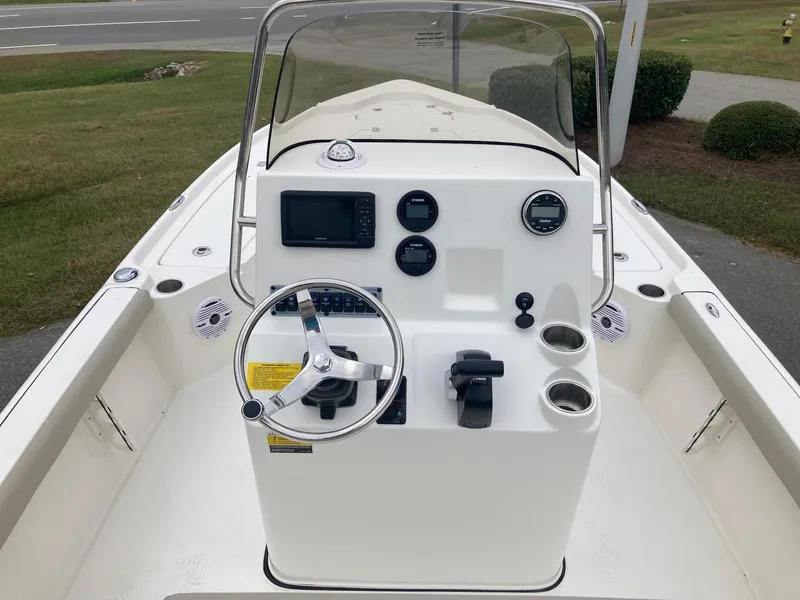 Slide: The Image of 2024 Key West 210 Bay Reef boat console with steering wheel and navigation controls. - 5