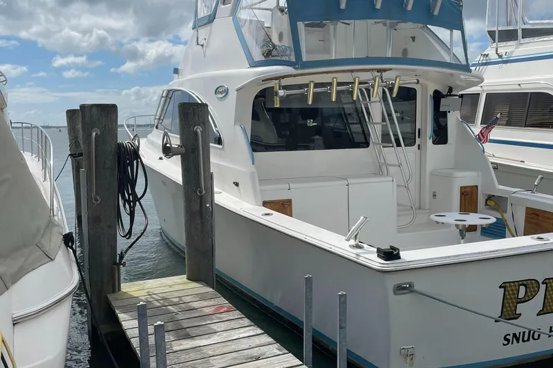 Slide: The Image of 1998 Ocean Yachts 40 Sport Fish docked at marina under cloudy sky. - 10