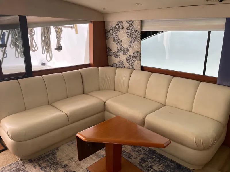 Slide: The Image of 1998 Ocean Yachts 40 Sport Fish interior with beige leather seating and wooden table. - 15