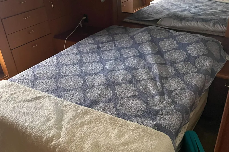 Slide: The Image of Cozy bedroom interior of 1998 Ocean Yachts 40 Sport Fish with patterned bedding. - 19