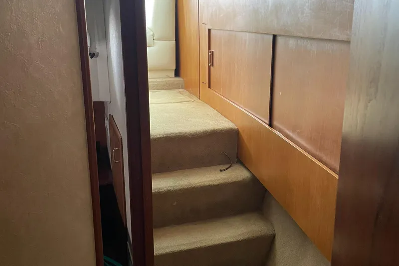 Slide: The Image of Interior view of 1998 Ocean Yachts 40 Sport Fish, featuring carpeted stairs and wooden cabinetry. - 22