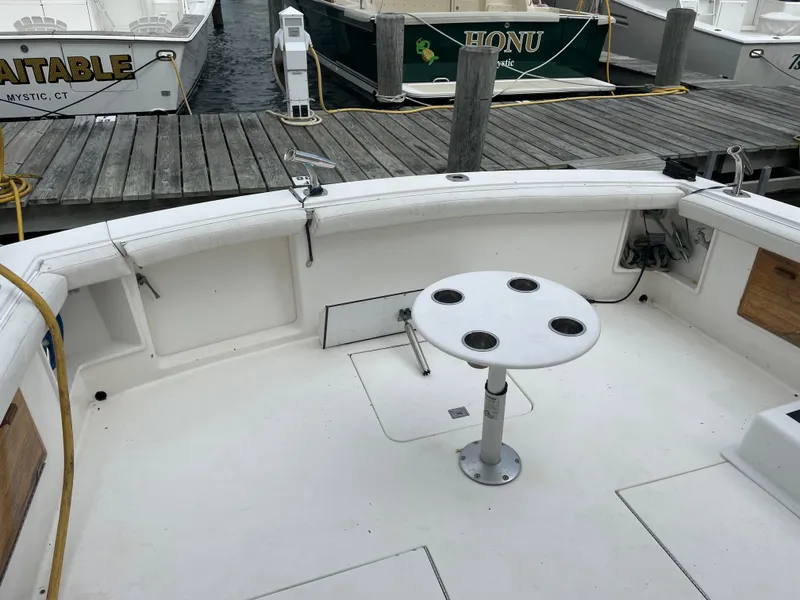 Slide: The Image of 1998 Ocean Yachts 40 Sport Fish boat deck with round table, docked at marina. - 9