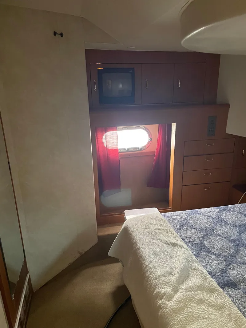 Slide: The Image of Interior cabin of 1998 Ocean Yachts 40 Sport Fish with bed, window, and storage. - 14