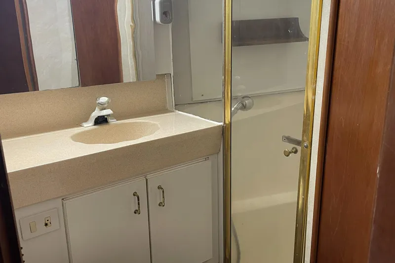 Slide: The Image of Bathroom interior of 1998 Ocean Yachts 40 Sport Fish with sink and shower. - 17
