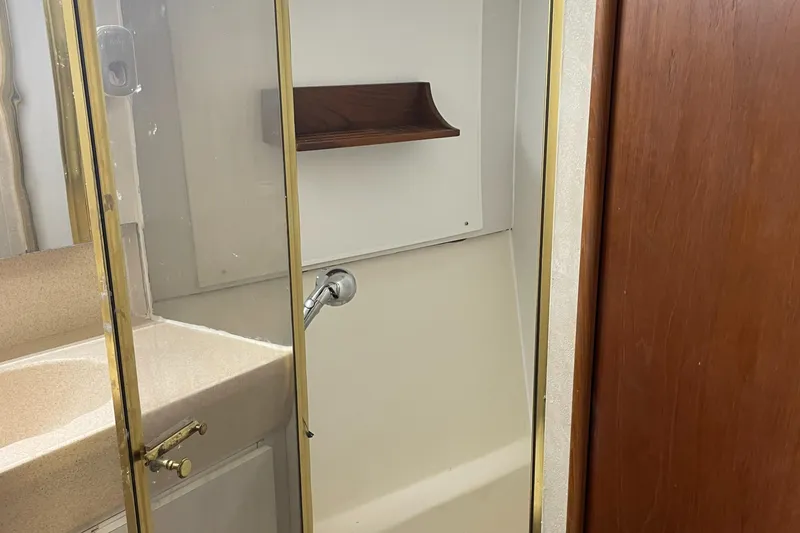Slide: The Image of Bathroom interior of 1998 Ocean Yachts 40 Sport Fish with shower and sink. - 18