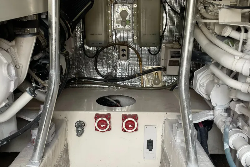 Slide: The Image of Engine room of 1998 Ocean Yachts 40 Sport Fish, showcasing mechanical components and wiring. - 25