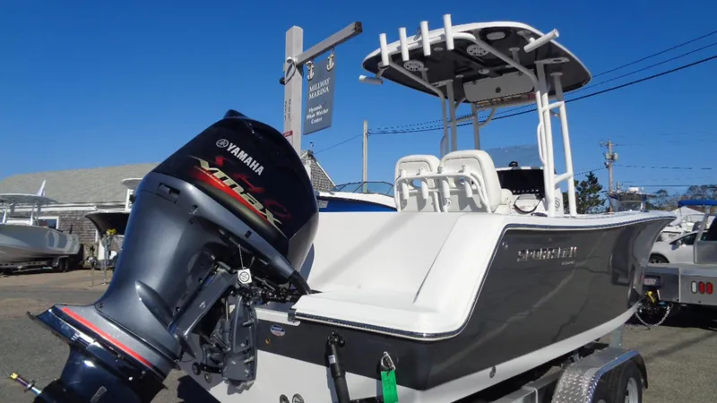Slide: The Image of 2020 Sportsman 231 Heritage boat with Yamaha outboard motor, parked on a trailer. - 2
