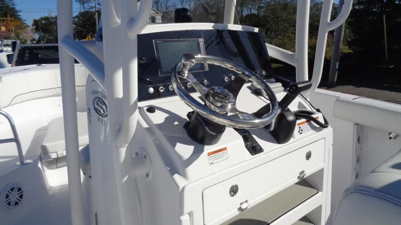 Slide: The Image of 2020 Sportsman 231 Heritage boat dashboard with steering wheel and controls. - 7