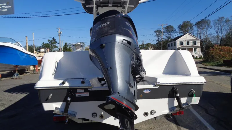Slide: The Image of 2020 Sportsman 231 Heritage boat with powerful outboard motor, parked outdoors. - 9