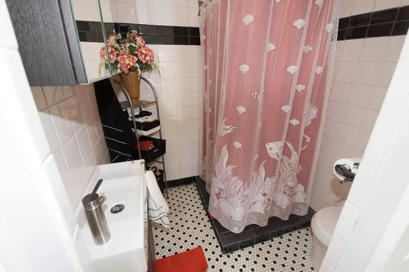 Slide: The Image of Compact bathroom in 2017 Chesapeake 48 Houseboat with floral shower curtain and decorative tiles. - 12