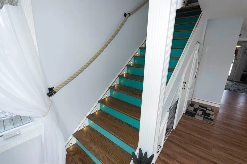 Slide: The Image of Staircase with teal steps and rope railing on 2017 Chesapeake 48 Houseboat. - 13